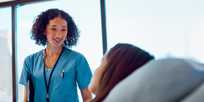 GettyImages-1530244286 woman healthcare worker talking to patient
