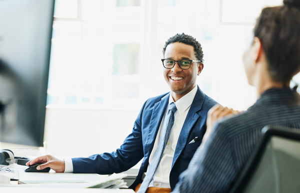 GettyImages-1682976602 Businessman in discussion with colleague in office