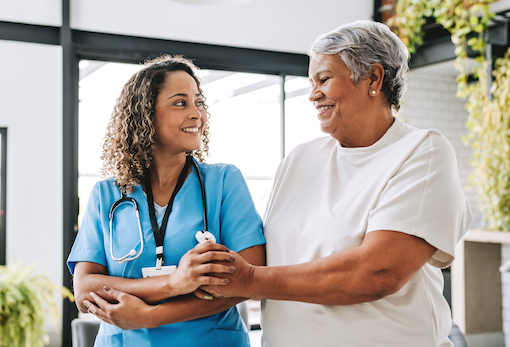 Nurse and patient holding hands and smiling
