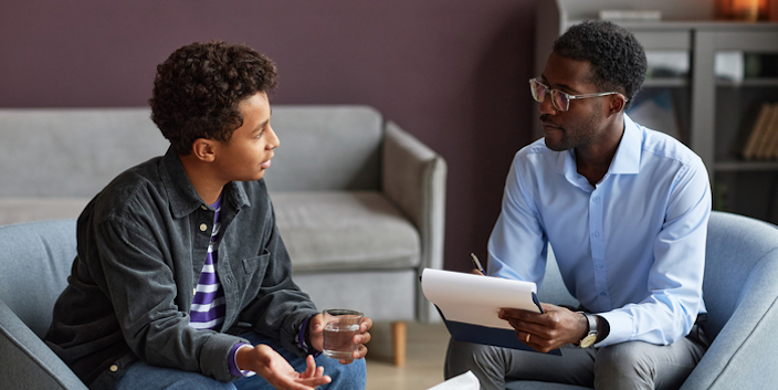 Small-GettyImages-1463773305 Two men sitting having a discussion